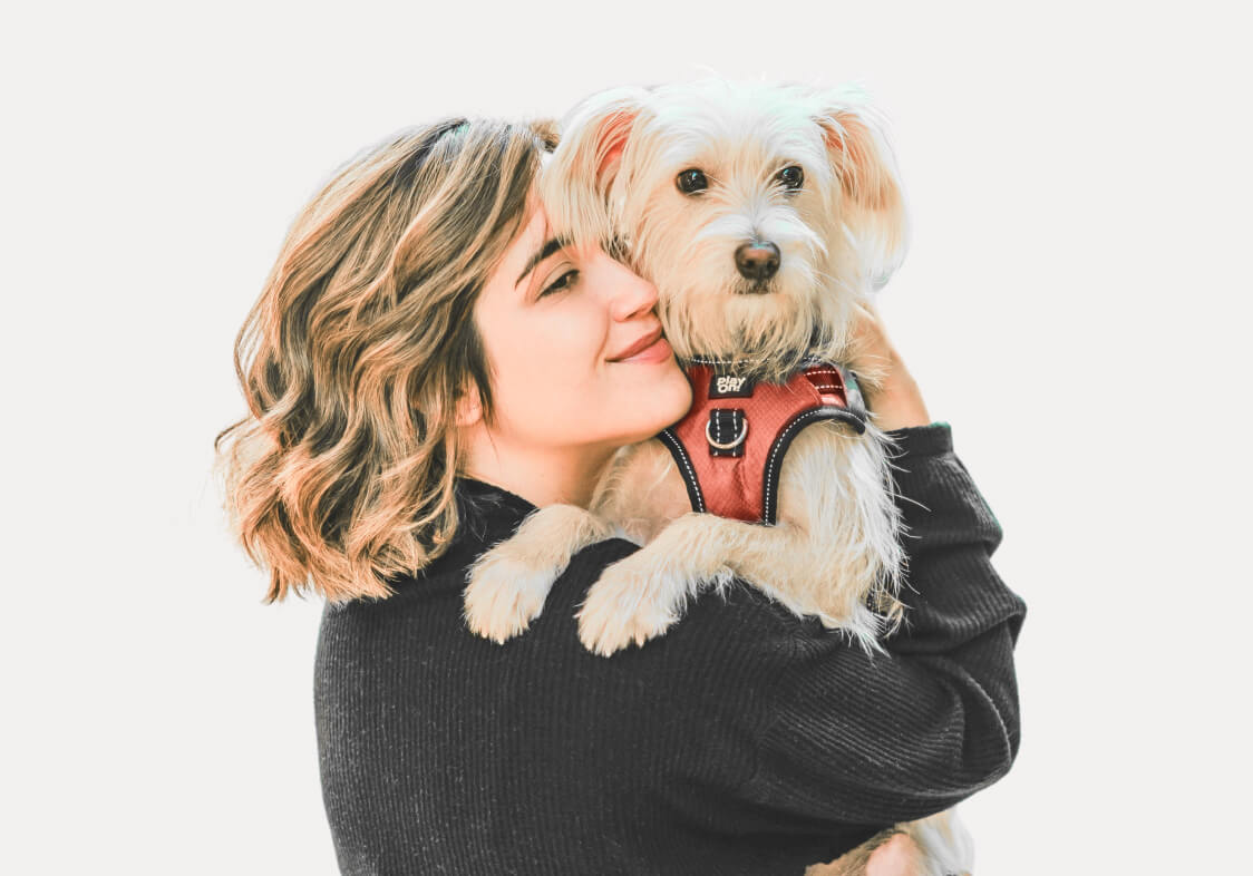 Smiling girl with a dog, side view